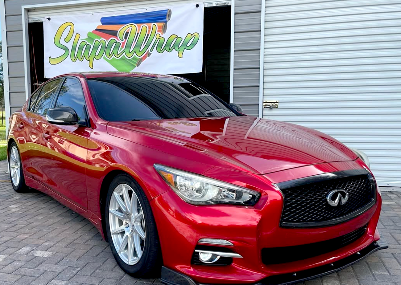 About SlapAWrap – Color Change Vehicle Wrap Experts SlapAWrap team applying a color change vehicle wrap in the shop